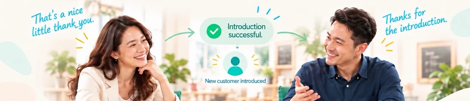 Two people smiling across a table after a successful introduction brings the Vendor a new customer